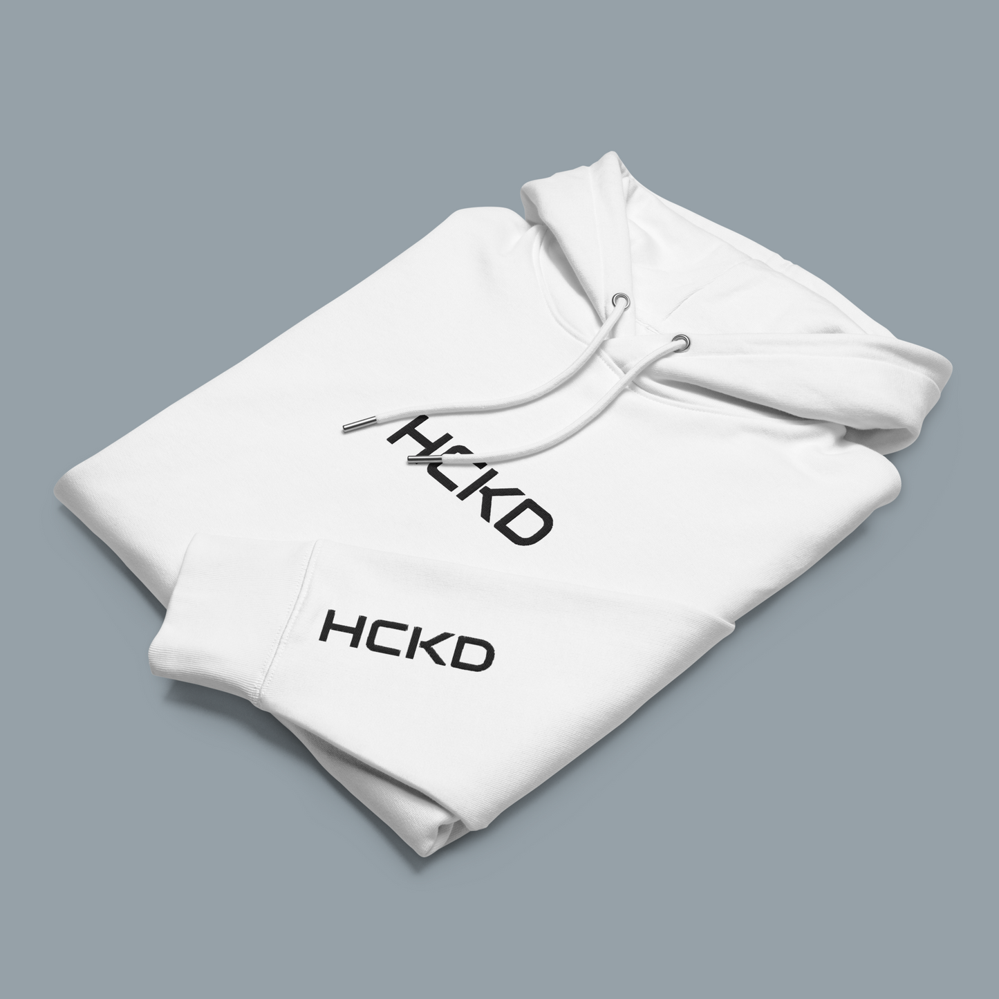HCKD HOOD-01 white hoodie folded with logo, featuring a modern fit and double-layered hood for all-day comfort.