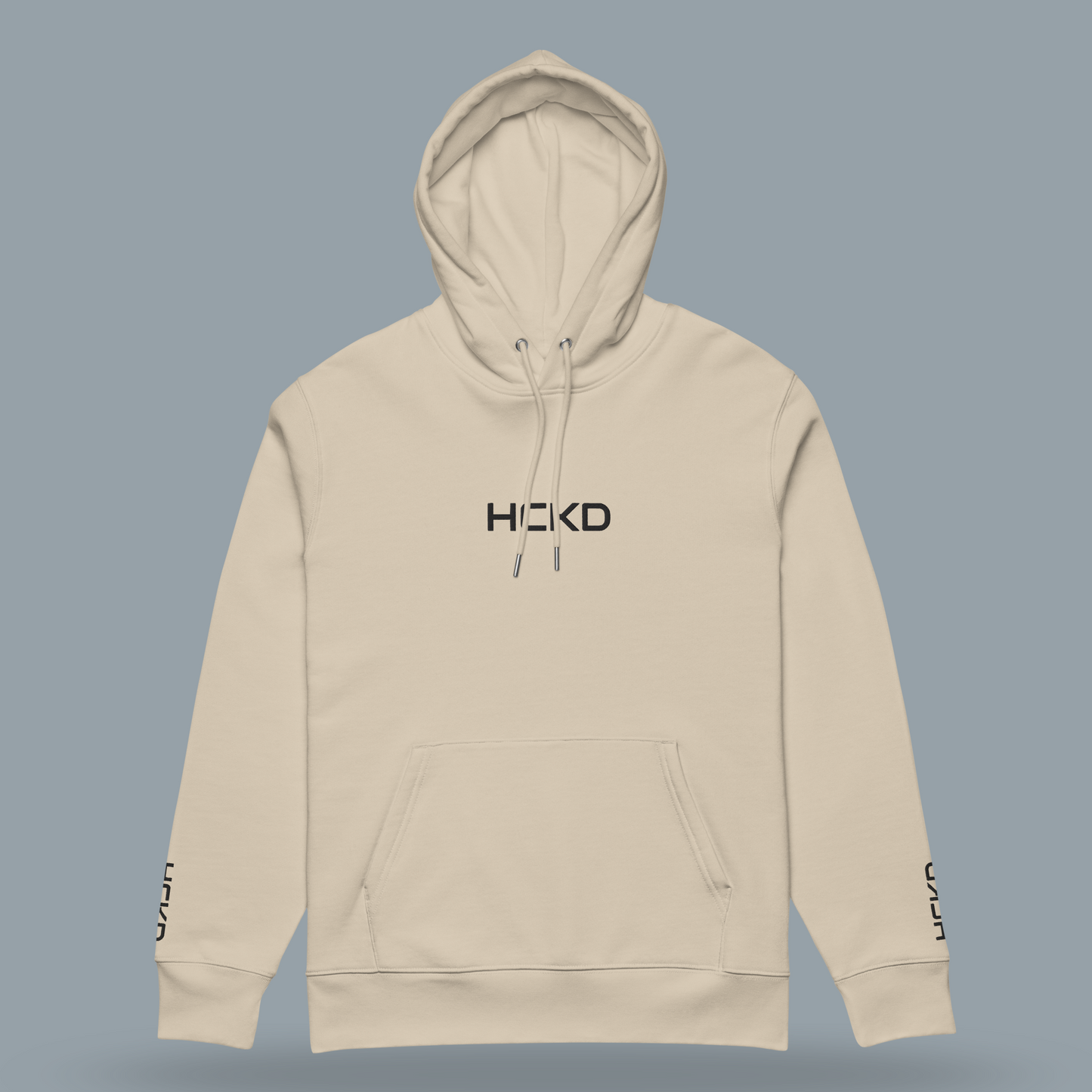 Light beige HCKD HOOD-01 hoodie featuring a modern fit, kangaroo pocket, and double-layered hood.