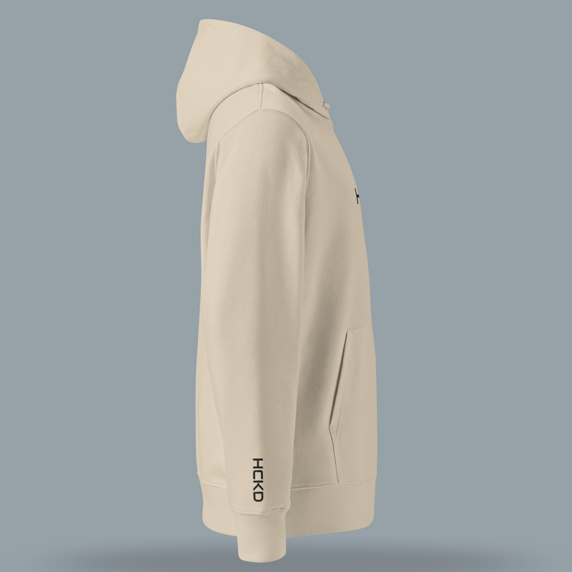 Light beige HCKD HOOD-01 hoodie showing modern fit, double-layered hood, and kangaroo pocket.